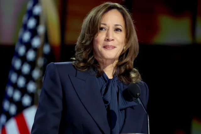 Vice President Kamala Harris, in a blue suit, speaks during the Democratic National Convention on Aug. 22, in Chicago.