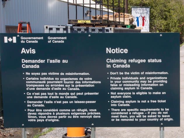 A sign warning asylum seekers is seen at the Canada-U.S. border at Roxham Road on May 9, 2018 in Champlain,NY.