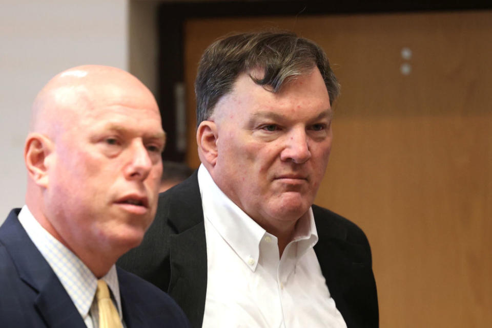 closeup of him and his lawyer in the courtroom