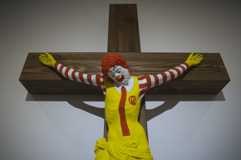 An artwork called "McJesus," which was sculpted by Finnish artist Jani Leinonen and depicts a crucified Ronald McDonald, is seen on display as part of the Haifa museum's "Sacred Goods" exhibit, in Haifa, Israel, Monday, Jan. 14, 2019. Hundreds of Christians calling for the sculpture's removal protested at the museum last week. (AP Photo/Oded Balilty)