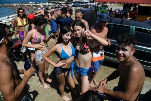Teenagers pose at Bahia de los Ninos beach in La Guaira
