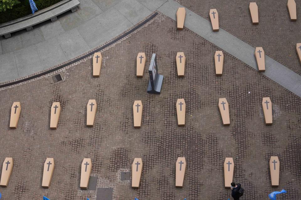 La Scala theatre square is filled with 172 coffins, as many as the number of deaths at work that Lombardy recorded in 2023, during a flash mob organised by UIL trade union organization, in Milan, Italy, Friday, May 10, 2024. (AP Photo/Luca Bruno)