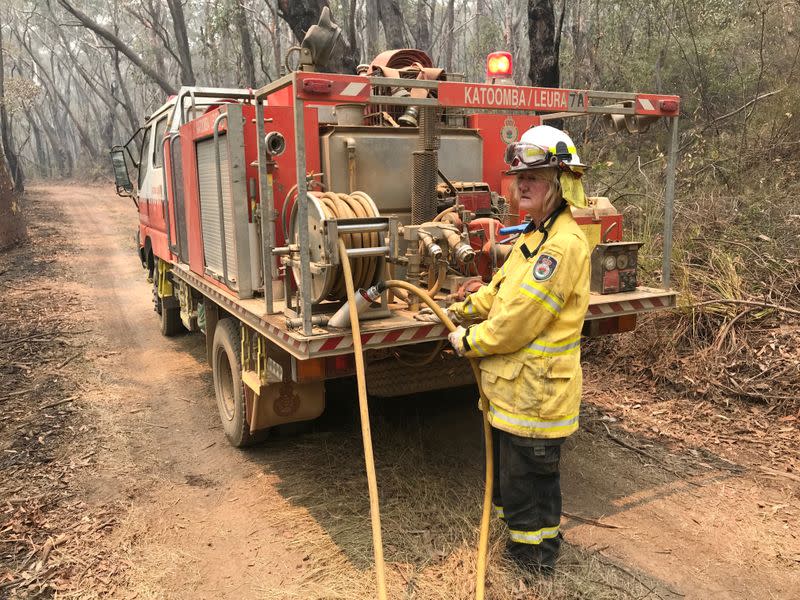 A volunteer from the New South Wales Rural Fire Service works to extinguish spot fires following back burning operations in Australia’s Blue Mountains