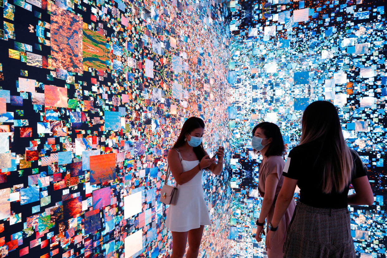 Visitors are pictured in front of an immersive art installation titled 