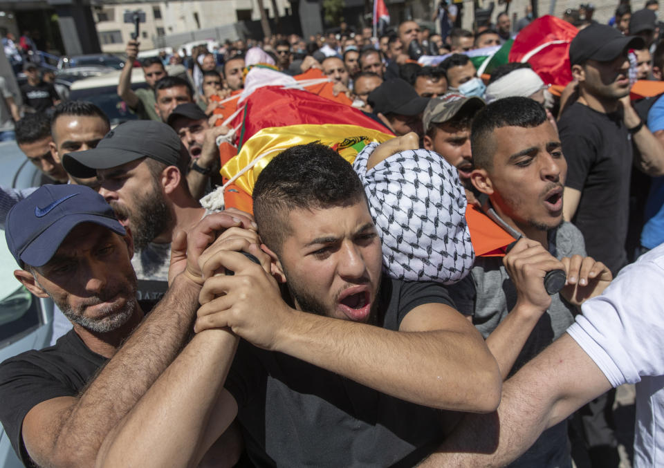 Palestinian mourners carry the bodies of Islam Bernat, 16, left and Adham Kashef, 20, during their funeral in the West Bank city of Ramallah, Wednesday, May 19, 2021. Multiple protesters were killed and more than 140 wounded in clashes with Israeli troops in Ramallah, Bethlehem, Hebron and other cities on Tuesday, according to the Palestinian Health Ministry. The Israeli army said at least a few soldiers were wounded in Ramallah by gunshots to the leg. (AP Photo/Nasser Nasser)