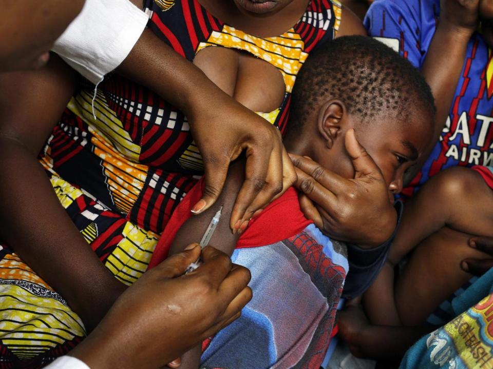 A child in Kinshasa receives a vaccine against yellow fever after dozens of organisations launched emergency vaccination campaigns (AP)