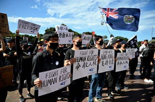 Supporters of the Hong Kong pro-democracy protesters hold placards during a demonstration as part of the global "anti-totalitarianism" movement in Sydney