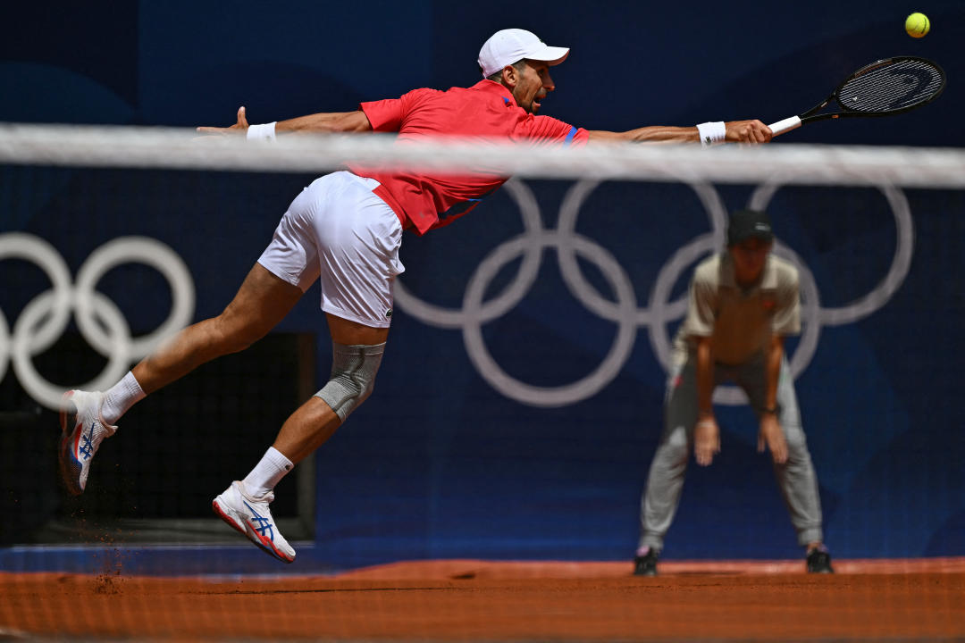 Serbia's Novak Djokovic returns to Spain's Carlos Alcaraz during their men's singles final tennis match on Court Philippe-Chatrier at the Roland-Garros Stadium during the Paris 2024 Olympic Games, in Paris on August 4, 2024. (Photo by Patricia DE MELO MOREIRA / AFP) (Photo by PATRICIA DE MELO MOREIRA/AFP via Getty Images)