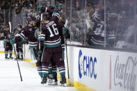 Anaheim Ducks players celebrate a goal by Ducks center Trevor Zegras (11) during the third period of an NHL hockey game against the Los Angeles Kings, Tuesday, April 9, 2024, in Anaheim, Calif. (AP Photo/William Liang)