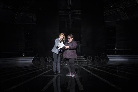 Rose Fostanes,47, a Filipina caregiver, (R) and Shiri Maimon, an Israeli pop singer and a judge in Israel's X-Factor talent show, prepare to sing during a rehearsal in Tel Aviv January 12, 2014. REUTER/Baz Ratner