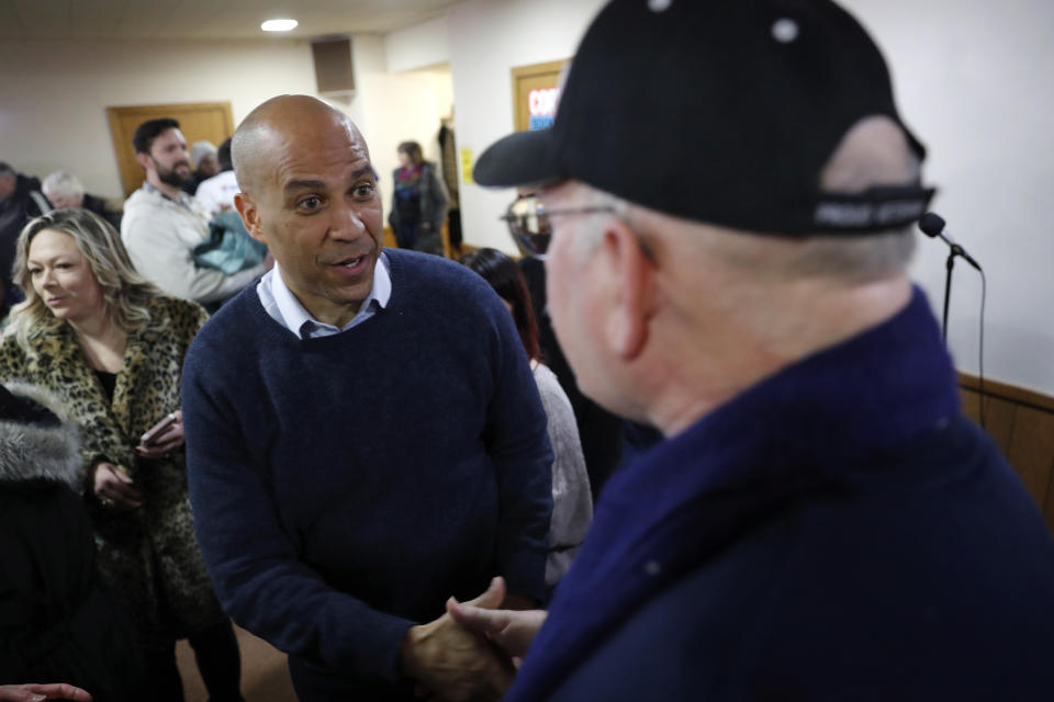 U.S. Sen. Cory Booker, D-N.J., speaks with Steven Howell, of Mason City, Iowa, right, during a meet and greet with local residents at the First Congregational United Church of Christ, Friday, Feb. 8, 2019, in Mason City, Iowa. (AP Photo/Charlie Neibergall)