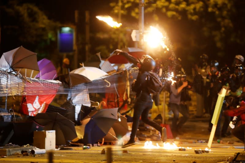 An anti-government protester throws a Molotov cocktail during the clashes with a police near the Polytechnic University in Hong Kong