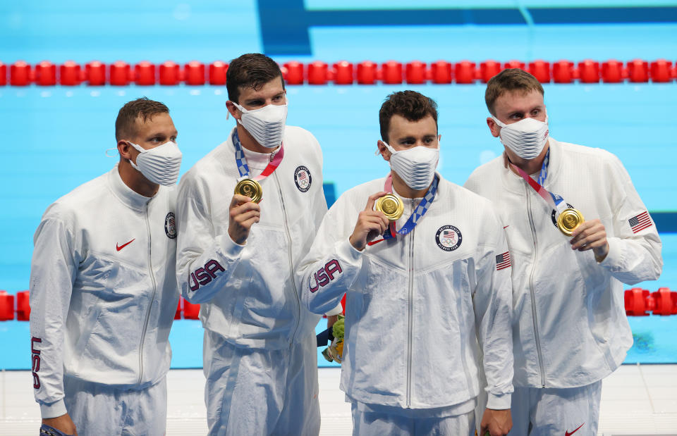 TOKYO, JAPAN - JULY 26: Caeleb Dressel, Zach Apple, Blake Pieroni, Bowen Becker of Team United States pose with their gold medals for the Men's 4 x 100m Freestyle Relay Final on day three of the Tokyo 2020 Olympic Games at Tokyo Aquatics Centre on July 26, 2021 in Tokyo, Japan. (Photo by Al Bello/Getty Images)