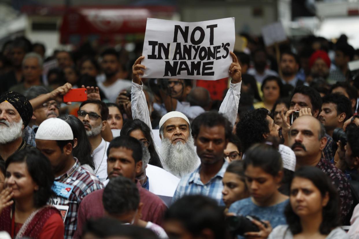 An Indian man holds a banner during a protest in Delhi against a spate of attacks across the country targeting the country's Muslim minority: AP