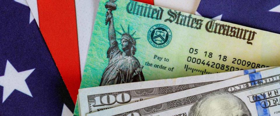 USA dollar cash banknote stimulus economic tax return check with US flag