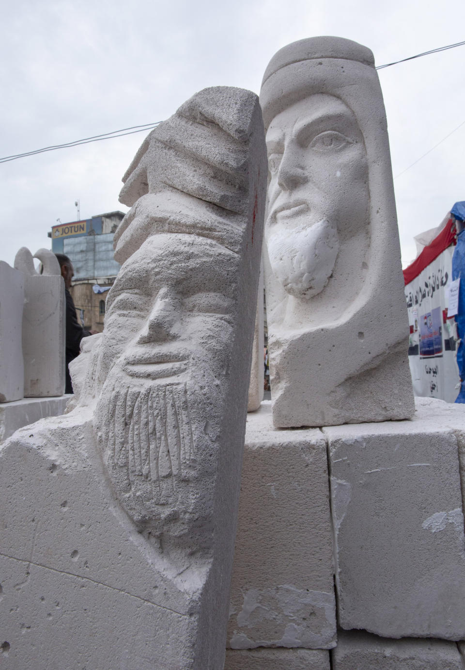 In this Monday, Dec. 16, 2019, photo, incomplete sculptures wait for the last touches before being stored in preparation for an upcoming art exhibition, during the ongoing protests in Tahrir square, Baghdad, Iraq. Tahrir Square has emerged as a focus of the protests, with protesters camped out in dozens of tents. Dozens of people took part in the simple opening of the sculpture exhibition. (AP Photo/Nasser Nasser)