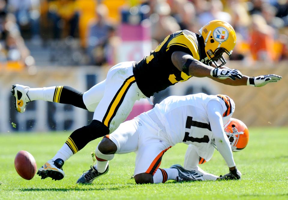 In this Oct. 17, 2010, file photo, Pittsburgh Steelers linebacker James Harrison (92) hits Cleveland Browns wide receiver Mohamed Massaquoi (11) during the second quarter of a an NFL football game in Pittsburgh.  Harrison was fined $75,000 on Tuesday, Oct. 19, 2010, for his hit against Massaquoi.