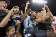 FILE - In this Aug. 29, 2019, file photo, Noah Lyles, of the United States, celebrates with fans after winning the men's 100m race during the Weltklasse IAAF Diamond League international athletics meet in Zurich, Switzerland. The most promising signal that track and field remains in good hands even after Usain Bolt’s retirement comes from a 22-year-old American named Noah Lyles who appreciates the Jamaican superstar more for what he did after his races than during them. When Lyles spends time studying Bolt on video, he looks not at the lanky speedster’s form in between the lines, but at the dancing, rollicking post-race celebrations Bolt concocted to make his sport can’t-miss viewing whenever he was on the track.(Jean-Christophe Bott/Keystone via AP, File)