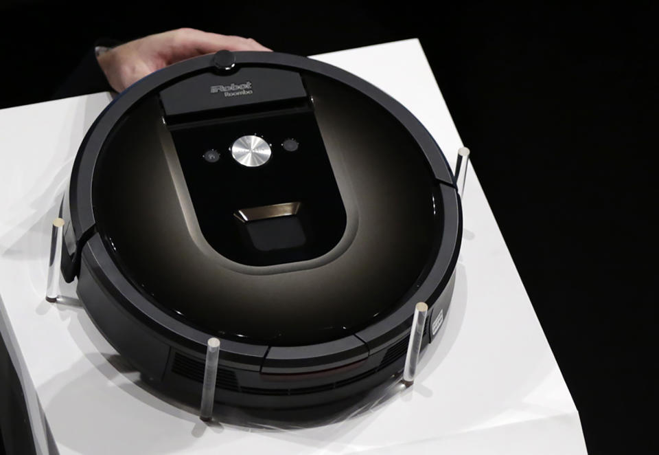 FILE - A Roomba 980 vacuum cleaning robot is presented during a presentation in Tokyo, Tuesday, Sept. 29, 2015. Amazon on Friday, Aug. 5, 2022, announced it has entered into an agreement to acquire the vacuum cleaner maker iRobot for approximately $1.66 billion. The company sells its robots worldwide and is most famous for the circular-shaped Roomba vacuum. (AP Photo/Eugene Hoshiko)