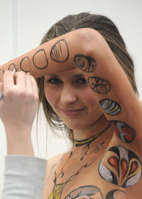 An artist paints a naked body during the IXth Cze ch Republic Body Painting Championships on March 31, 2012 as part of the ''Inter Beauty Prague 2012'' fair Prague. The theme of the contest is ''Lady from a picture of Czech Art Nouveau painter Alfons Mucha.''