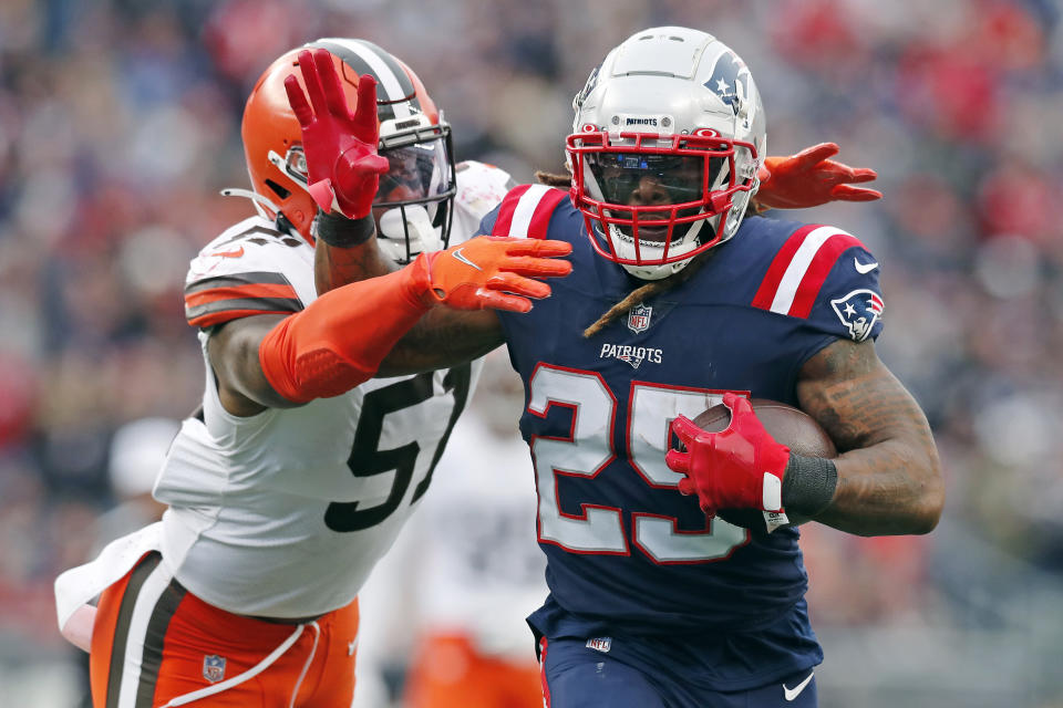 New England Patriots running back Brandon Bolden (25) tries to break free from Cleveland Browns outside linebacker Mack Wilson (51) during the second half of an NFL football game, Sunday, Nov. 14, 2021, in Foxborough, Mass. (AP Photo/Michael Dwyer)