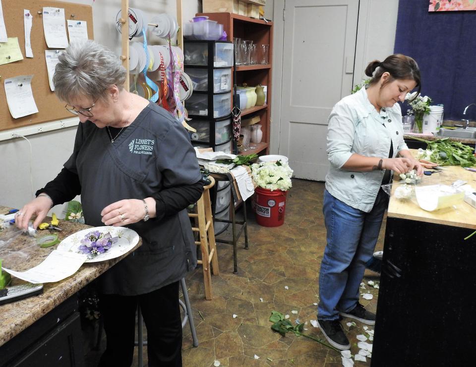 Linnet Lowe and her daughter, Amanda Stickdorn, work on orders together at Linnet's Flowers on the Square in Newark. The original store is in Coshocton and opened 27 years ago.