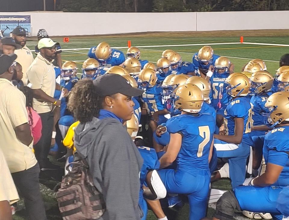 Mainland head coach Travis Roland (white cap) addresses his Buccaneers following Friday night's lopsided loss to Lake Mary.