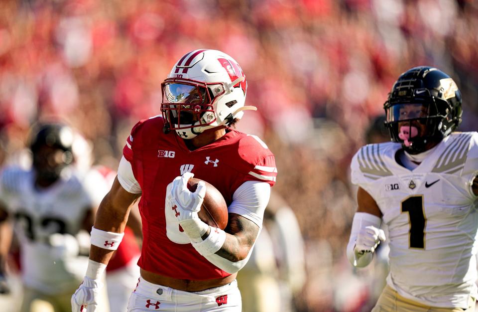 Wisconsin running back Braelon Allen runs against Purdue defensive back Reese Taylor (1) for a first down during the first half of an NCAA college football game Saturday, Oct. 22, 2022, in Madison, Wis. (AP Photo/Andy Manis)