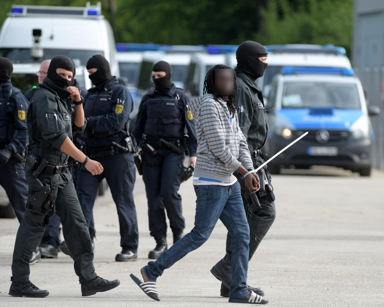 Polizisten führen einen Geflüchteten aus der Unterkunft in Ellwangen ab (Bild: dpa)