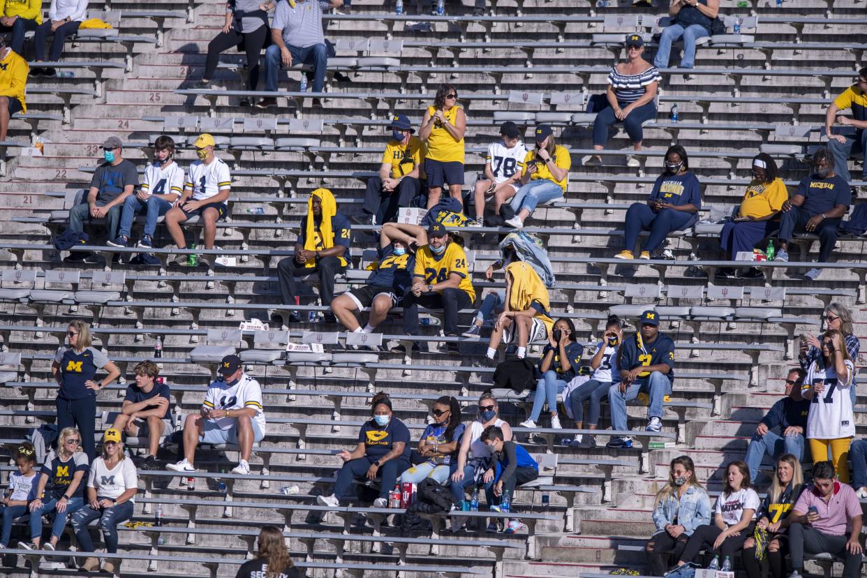 Michigan fans watch the action on the field during the second half of an NCAA college football game against Indiana on Nov. 7, 2020, in Bloomington, Ind. Indiana won 38-21. The COVID-19 pandemic has limited the size of crowds at events.