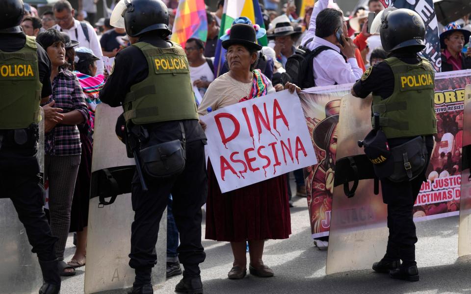 An anti-government protester shows her disapproval of Dina Boluarte
