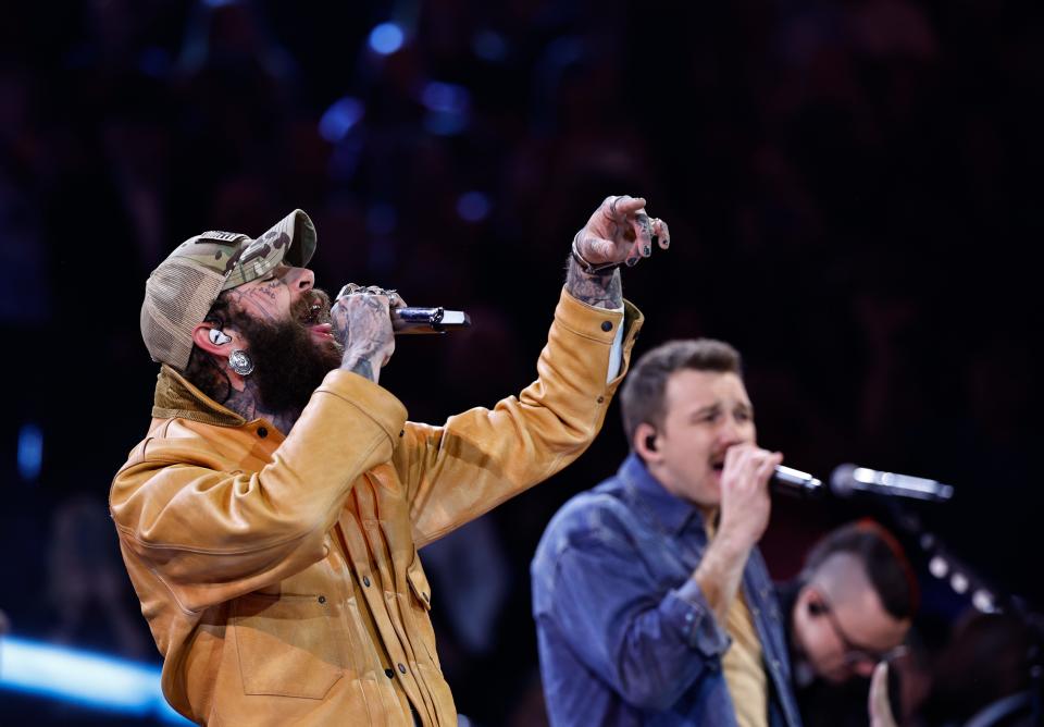Post Malone performs with Morgan Wallen during the 57th Annual Country Music Association Awards in Nashville, Tenn., Wednesday, Nov. 8, 2023.