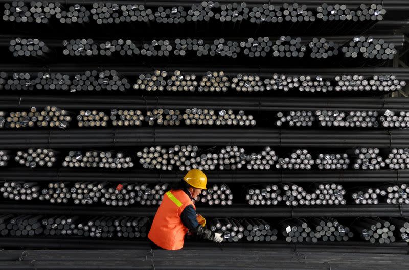 A labourer marks steel bars at a steel and iron factory in Huai'an