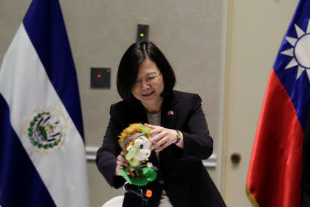 Taiwan's President Tsai Ing-wen plays with a doll during an event in San Salvador, El Salvador January 12, 2017. REUTERS/Jose Cabezas