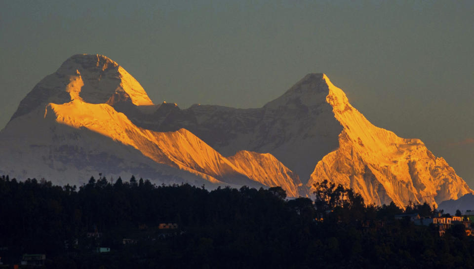 In this Oct. 7, 2016, photograph provided by Juniper Outdoor Pursuits Centre Pvt. Ltd., shows Nanda Devi twin peaks which are connected with a razor sharp ridge with a distance of around 2 kilometers running at approximately 6666m height or 22,000 feet, seen from Chaukori in Uttarakhand, India. Indian air force pilots have resumed a search over a Himalayan mountain for a team of mostly foreign climbers missing since late May. The fourth day of the search on Tuesday was taking place in the northern state of Uttarakhand after five bodies were spotted in the snow in high-resolution photos taken Monday. (AP Photo/ Maninder Kohli via Juniper Outdoor Pursuits Centre Pvt. Ltd)