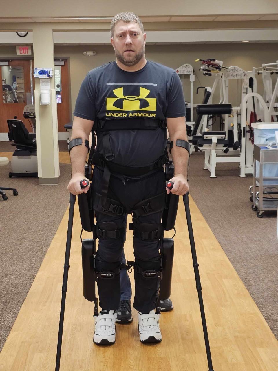 Brian Ortner stands and walks using a Rewalk Robotics exoskeleton. Ornter uses the bionic device to help develop aerobic fitness, strenghen his bones and bolster his gut health.
