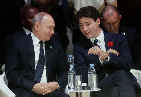 Russian President Vladimir Putin and Canadian Prime Minister Justin Trudeau attend the opening session of the Paris Peace Forum as part of the commemoration ceremony for Armistice Day, 100 years after the end of the First World War, in Paris, France, November 11, 2018. Sputnik/Mikhail Metzel/Kremlin via REUTERS