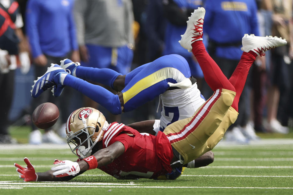 San Francisco 49ers wide receiver Brandon Aiyuk, bottom, cannot catch a pass while defended by Los Angeles Rams cornerback Tre'Davious White during the first half of an NFL football game, Sunday, Sept. 22, 2024, in Inglewood, Calif. (AP Photo/Ryan Sun)