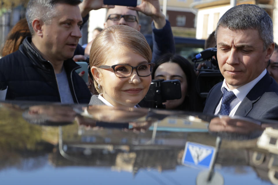 Former Ukrainian Prime Minister Yulia Tymoshenko, a candidate for the presidential election, center, leaves a polling station after casting during the presidential election in Kiev, Ukraine, Sunday, March 31, 2019. Ukrainians choose from among 39 candidates for a president they hope can guide the country of more than 42 million out of troubles including endemic corruption, a seemingly intractable conflict with Russia-backed separatists in the country's east and a struggling economy. (AP Photo/Sergei Grits)