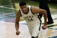 Milwaukee Bucks' Giannis Antetokounmpo reacts after his dunk during the first half of an NBA basketball game Tuesday, Feb. 23, 2021, in Milwaukee. (AP Photo/Morry Gash)