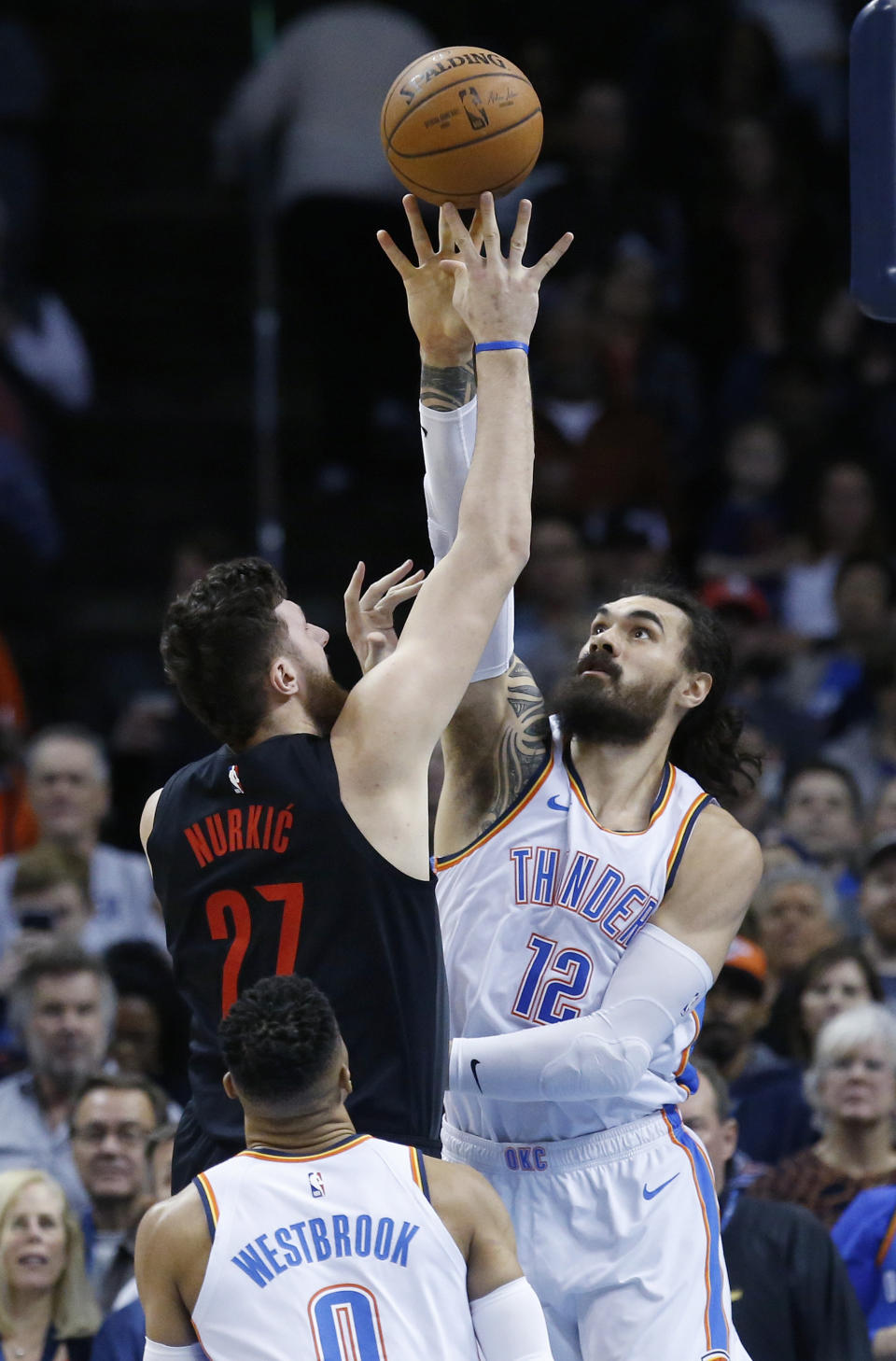 Portland Trail Blazers center Jusuf Nurkic (27) shoots as Oklahoma City Thunder center Steven Adams (12) defends in the first half of an NBA basketball game in Oklahoma City, Monday, Feb. 11, 2019. (AP Photo/Sue Ogrocki)