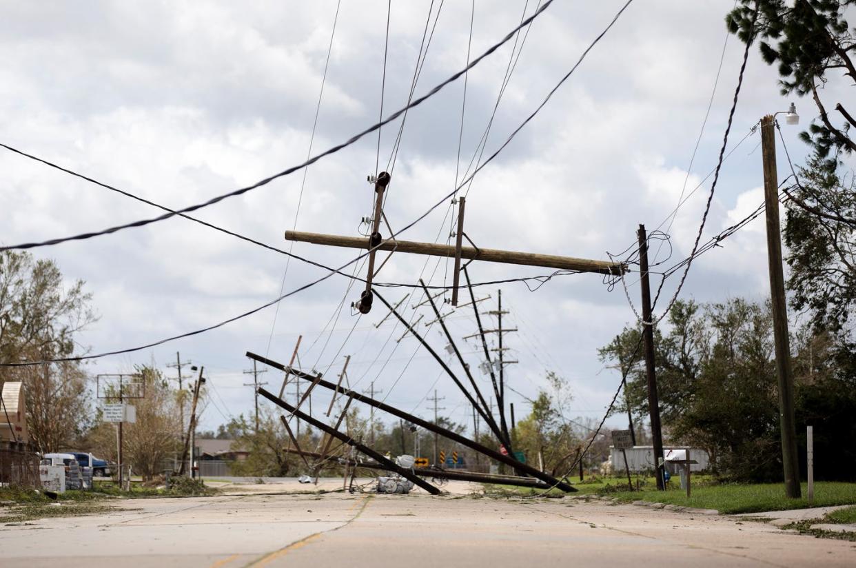 <span class="caption">Power poles downed by Hurricane Ida in Houma, Louisiana, Aug. 30, 2021.</span> <span class="attribution"><a class="link " href="https://www.gettyimages.com/detail/news-photo/power-line-poles-are-seen-downed-by-hurricane-ida-in-houma-news-photo/1234971730" rel="nofollow noopener" target="_blank" data-ylk="slk:Nick Wagner/Xinhua via Getty Images;elm:context_link;itc:0;sec:content-canvas">Nick Wagner/Xinhua via Getty Images</a></span>