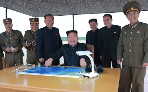 North Korean leader Kim Jong Un inspects the long and medium-range ballistic rocket launch drill on Tuesday - Credit: KCNA/Reuters