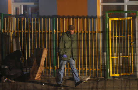 A forensic personnel walks in front of a betting shop after an attack in Sarajevo, November 19, 2015. REUTERS/Dado Ruvic