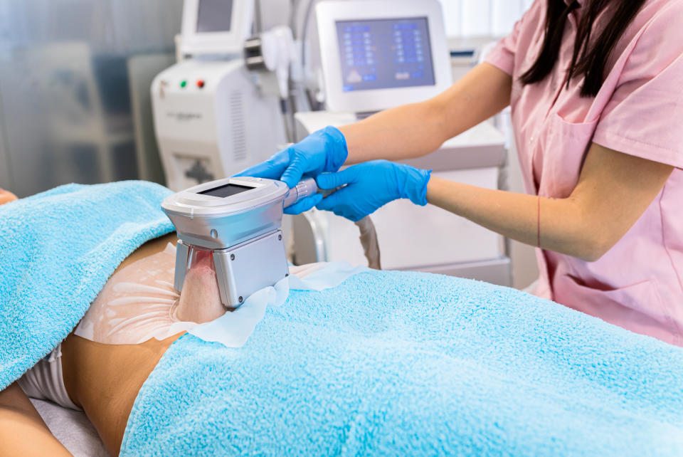 A person undergoing non-invasive body contouring treatment in a clinic