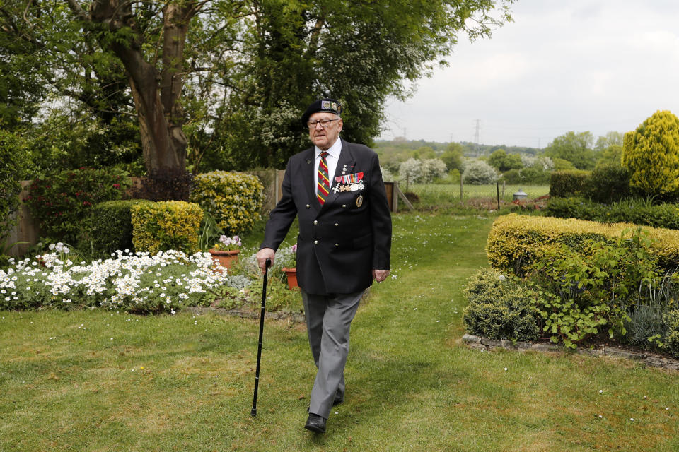World War II veteran Ken Hay walks in his garden in London, Monday, May 4, 2020. VE-Day was the end of four days of celebration for Ken Hay. It began when the former prisoner of war got his first sight of home in almost a year from a Lancaster bomber he flew back in. (AP Photo/Frank Augstein)