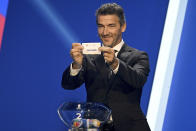 Karl-Heinz Riedle, former soccer player and soccer official, holds the lot of England during the draw for the groups to qualify for the 2024 European soccer championship in Frankfurt, Germany, Sunday, Oct.9, 2022. (Arne Dedert/dpa via AP)