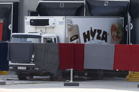 A truck discovered abandoned on an Austrian motorway containing more than 70 bodies sits at a customs building with refrigeration facilities in the village of Nickelsdorf, Austria, August 28, 2015. REUTERS/Heinz-Peter Bader