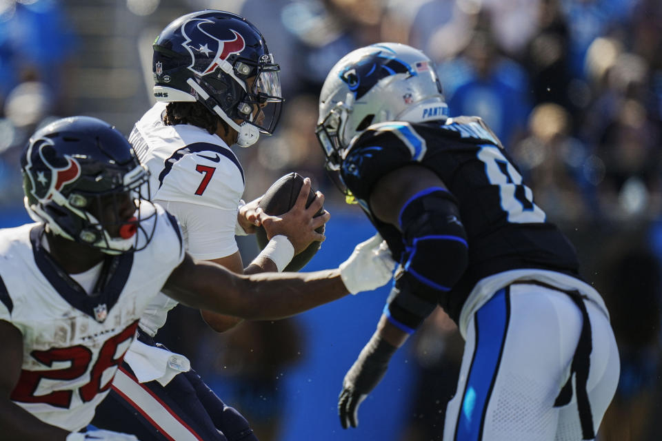 Houston Texans quarterback C.J. Stroud (7) runs out of the pocket against Carolina Panthers linebacker Brian Burns (0) during the first half of an NFL football game, Sunday, Oct. 29, 2023, in Charlotte, N.C. (AP Photo/Rusty Jones)