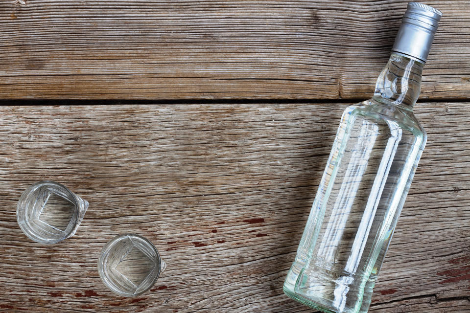 VODKA luxury. Vodka in a bottle and glasses on a background of wood.